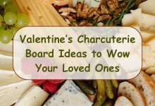 Beautiful Valentines charcuterie board with pink and red treats arranged in heart shapes