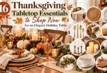 Elegant Thanksgiving tabletop essentials featuring neutral linens, woven chargers, white dinnerware, gold flatware, amber glassware, candles, pumpkins, and seasonal greenery.