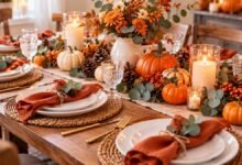 Simple Thanksgiving table setting with everyday white dishes, pumpkins, greenery, and linen napkins