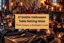 Elegant gothic Halloween table setting with black plates, candles, and dark floral centerpiece